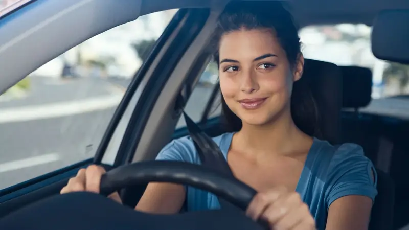 Driver smiling behind the wheel